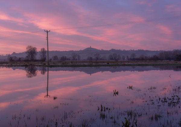 The reflection of Glastonbury Tor on a flooded Somerset Levels